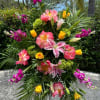 A standing spray for a funeral service with high end blooms in