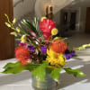 Colorful tropical flower arrangement in a glass vase
