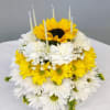 Tiered yellow and white flower cake with candles