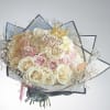 Bouquet of cream and pink roses with a "Happy Birthday" topper