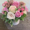 Pink and white rose bouquet in a white vase