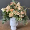 Peach and cream rose bouquet in a white vase