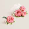 Soft pink spray roses and tiny white filler blooms form a romantic