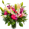 Pink peonies and lilies in a clear glass vase