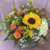 Bouquet with a sunflower, orange roses, and white hydrangea in a square vase