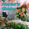 Florist arranging a pink and peach bouquet with large text overlay