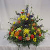 Colorful floral arrangement around a dark vase centerpiece