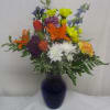 Vivid orange Asiatic lilies and fiery red-orange tulips take center stage in