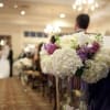 White and purple wedding bouquet in a clear vase