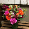 Bright mixed bouquet in a glass vase with orange gerberas and pink carnations