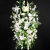 Tall white floral spray with lilies and mixed blooms
