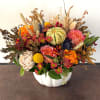 Mixed bouquet in a white pumpkin-shaped vase with roses and mums