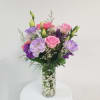 Pink, purple, and white bouquet in a clear glass vase