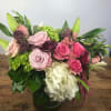 A charming French-style arrangement featuring a delicate mix of garden roses, lush