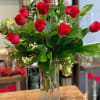 A timeless expression of love and beauty, this arrangement features a dozen