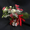 Christmas bouquet in a snowman container with red ribbon
