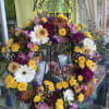 A beautiful multicolored tribute wreath that celebrates a bright and full life