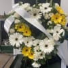 Heart-shaped floral wreath with white and yellow daisies and roses