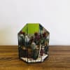 Small terrarium with cacti and succulents in a geometric glass container