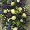 Large standing spray with white roses, blue flowers, and purple orchids
