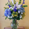 Blue and white flower arrangement in a clear glass vase