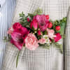 Pink and red floral corsage with roses and alstroemeria