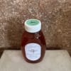 Bottle of honey with a white cap and label