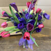 Bouquet of purple and pink flowers in a clear vase