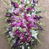Large standing spray of purple, pink, and white flowers