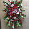 Large standing floral spray with red, white, and pink blooms