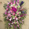 Large pink and purple floral spray with lilies and roses