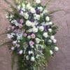 Standing floral spray with white and pink roses and purple accents