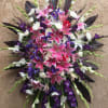 Large bouquet of pink lilies, white flowers, and purple blooms
