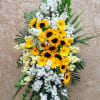 Standing floral spray with yellow sunflowers and white blooms