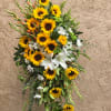 Tall floral spray with sunflowers, white lilies, and daisies