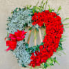 Heart-shaped red rose wreath with white baby's breath and a red bow