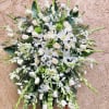 Large white floral spray with lilies, roses, and daisies
