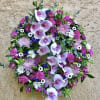 Circular floral wreath with pink orchids and mixed purple-white flowers