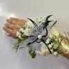 White floral wrist corsage with black ribbon and tulle