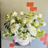 White lilies and chrysanthemums in a white basket