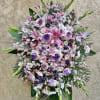 Large standing floral spray with pink and lavender blooms