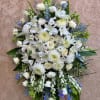 Large white funeral spray with lilies and chrysanthemums