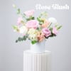 Pink and white roses arranged in a white vase