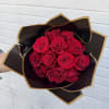 Bouquet of red roses wrapped in black and gold paper