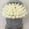 Round box of tightly packed white roses in a gray hatbox printed with L'amour Toujours