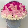 Round hatbox packed with ombre roses from fuchsia to blush pink to ivory