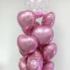 Cluster of pink heart balloons with a clear Happy Birthday balloon on top