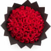 A bold, dome-shaped bouquet of tightly packed red roses that reads as