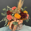 A rustic embrace of autumn&rsquo;s gentler side. Marmalade roses and coral carnations