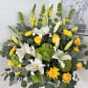 Sunlit white lilies and sunny yellow roses create a joyful, uplifting presence